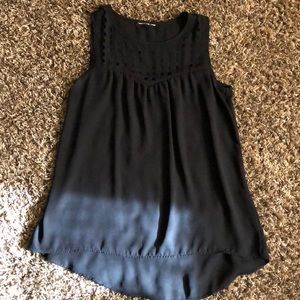 Black flowing tank top with pattern on top.